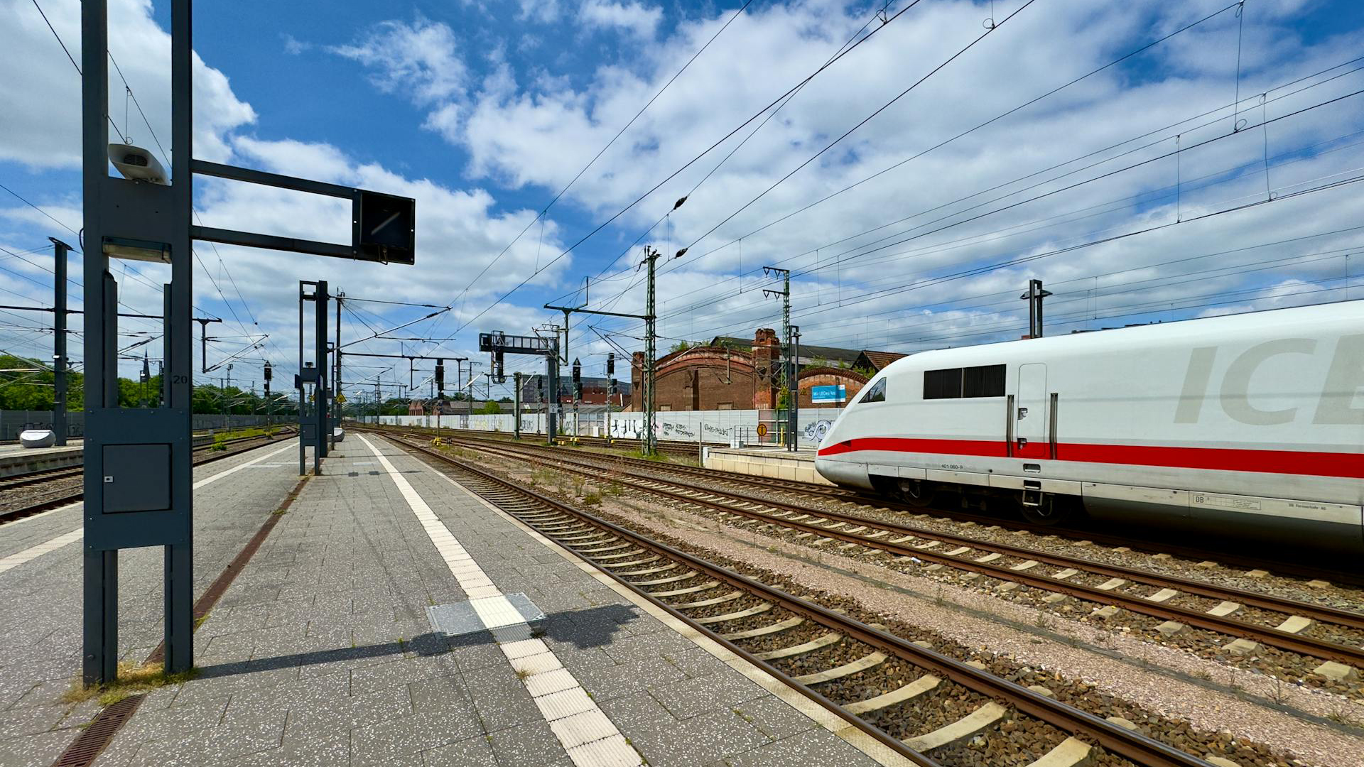 Intercity-Express (ICE) train leaving the station under blue skies